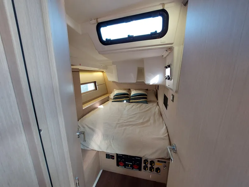 Slide: The Image of 2022 Beneteau Oceanis 46.1 cabin interior with bed and window view. - 40