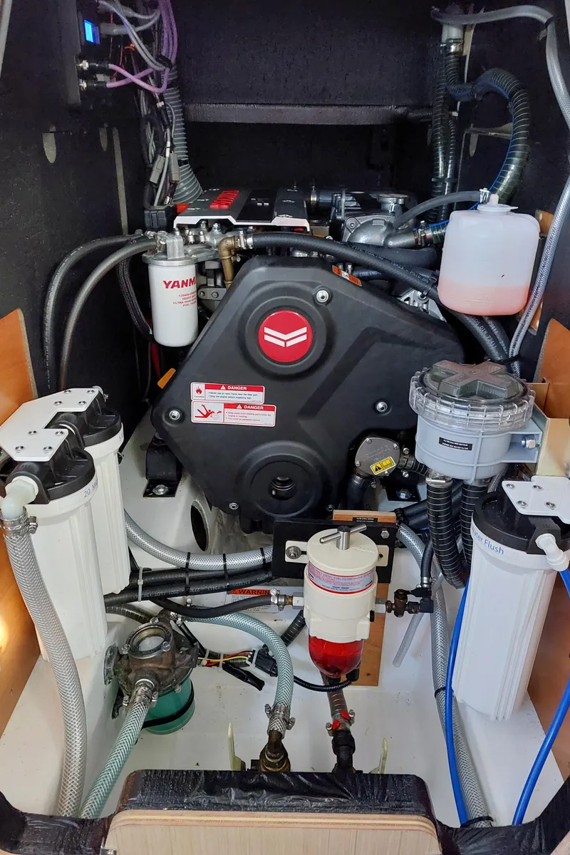 Slide: The Image of Engine compartment of a 2022 Beneteau Oceanis 46.1 sailboat, showcasing mechanical components and filters. - 47