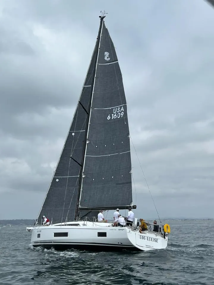 Slide: The Image of 2022 Beneteau Oceanis 46.1 sailboat on open water under cloudy skies. - 8