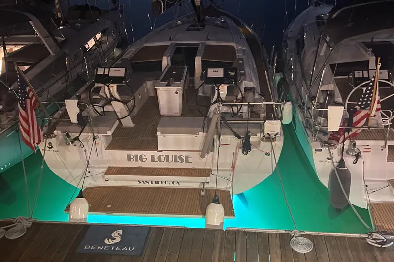 Slide: The Image of 2022 Beneteau Oceanis 46.1 yacht docked at night with glowing underwater lights. - 9