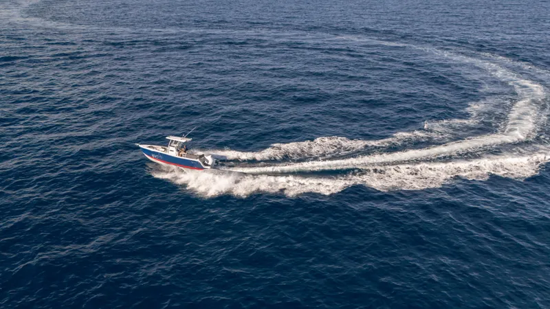 Slide: The Image of Aerial view of 2025 SeaWell 240CC boat making a circular wake in the ocean. - 12