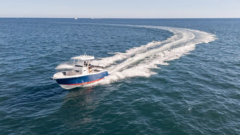 Slide: The Image of 2025 SeaWell 240CC boat cruising on open ocean, leaving a trail of white wake. - 13