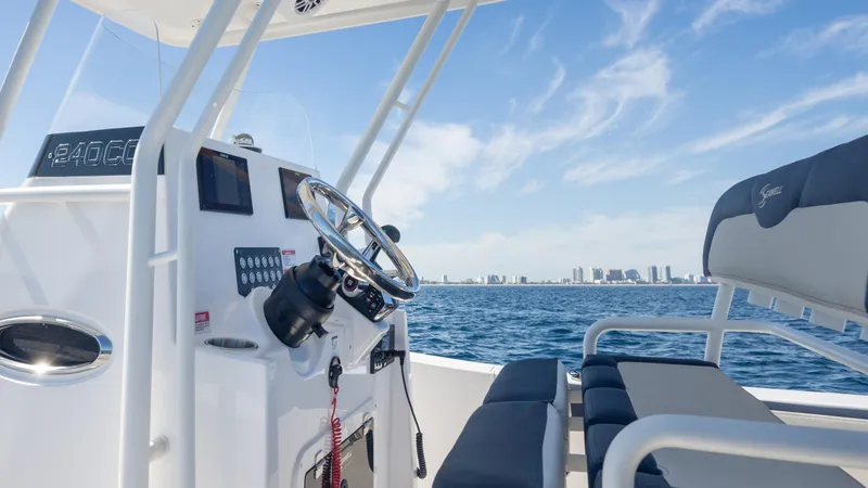 Slide: The Image of 2025 SeaWell 240CC boat interior with ocean view and city skyline in background. - 16