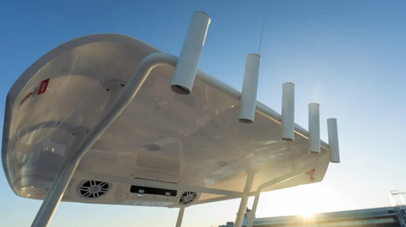 Slide: The Image of 2025 SeaWell 240CC boat underside with rod holders, against a clear sky. - 18