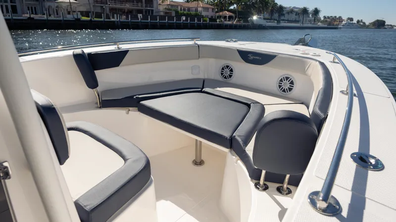 Slide: The Image of 2025 SeaWell 240CC boat interior with cushioned seating and waterfront view. - 20