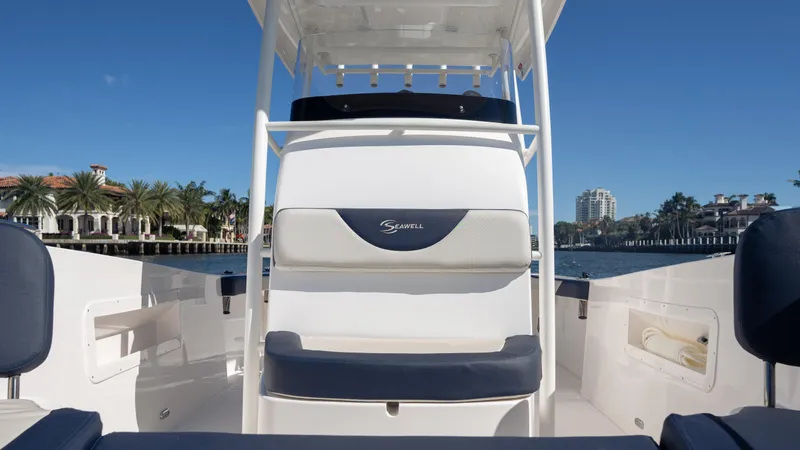 Slide: The Image of 2025 SeaWell 240CC boat interior with seating, set against a waterfront backdrop. - 21