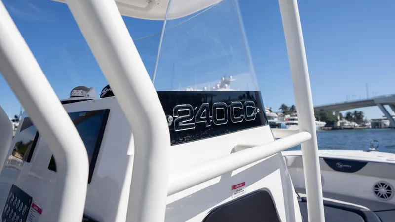 Slide: The Image of 2025 SeaWell 240CC boat console with clear skies and waterfront view. - 25