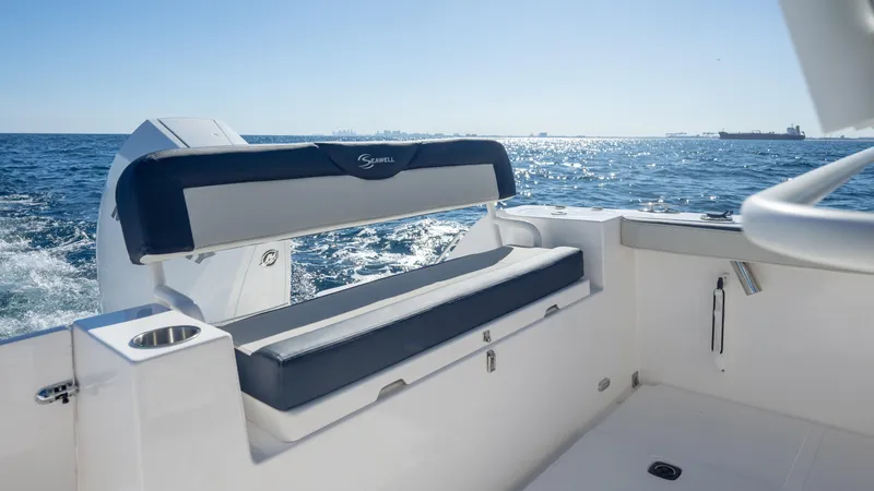 Slide: The Image of 2025 SeaWell 240CC boat interior with seating, ocean view, and clear blue sky. - 27