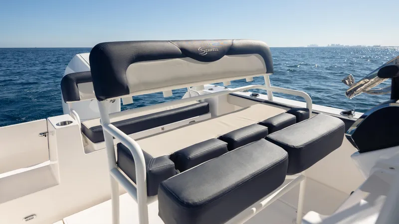 Slide: The Image of 2025 SeaWell 240CC boat interior with cushioned seating, ocean view in background. - 29