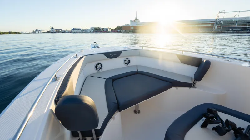 Slide: The Image of 2025 SeaWell 240CC boat interior with seating, on calm water at sunset. - 39
