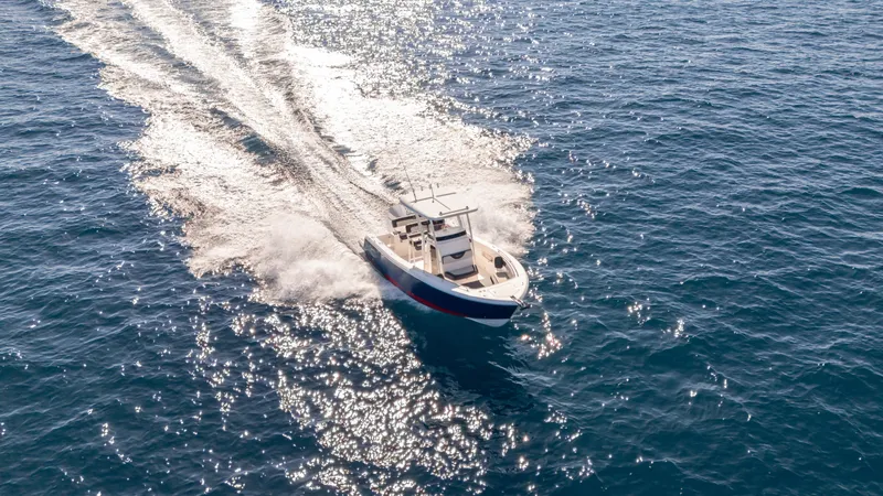 Slide: The Image of 2025 SeaWell 240CC boat cruising on open water, creating a sparkling wake. - 9