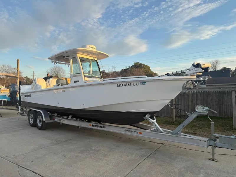 Slide: The Image of 2023 Everglades 273 Center Console boat on trailer, parked outdoors. - 1