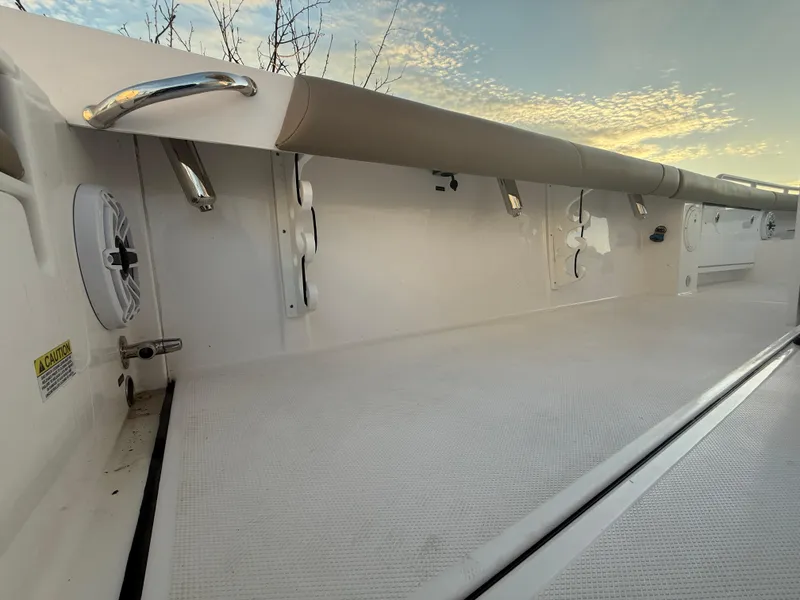 Slide: The Image of 2023 Everglades 273 Center Console boat interior with white deck and side railings. - 10