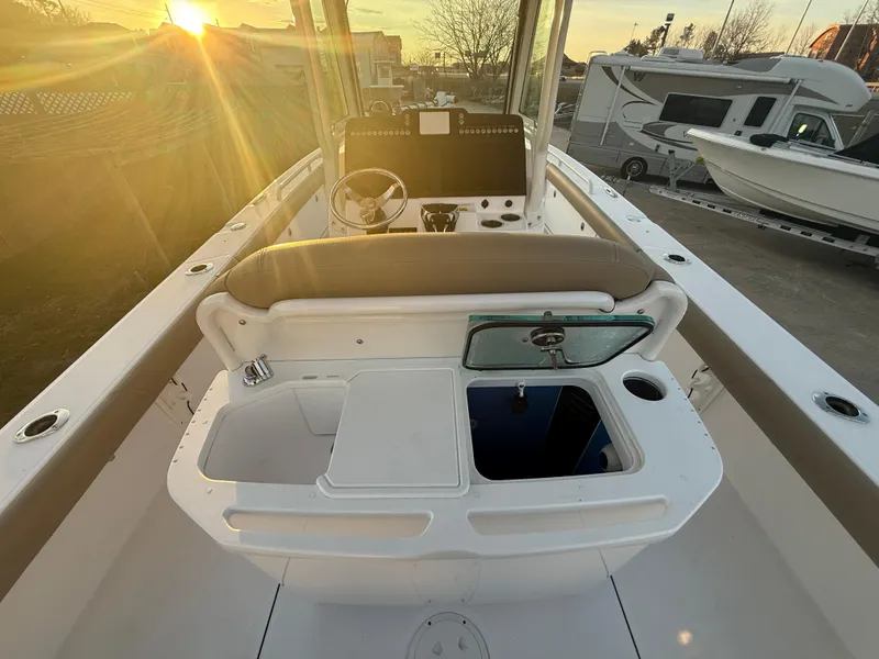 Slide: The Image of 2023 Everglades 273 Center Console boat interior at sunset, showcasing helm and seating area. - 12