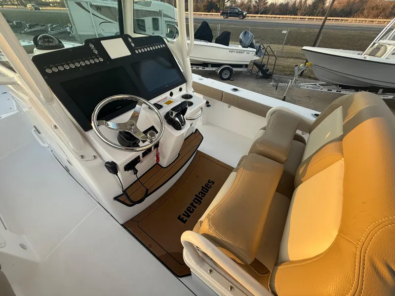Slide: The Image of 2023 Everglades 273 Center Console boat interior with helm and seating. - 13