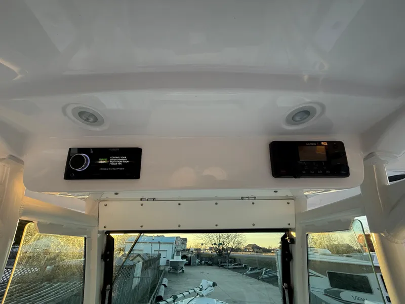 Slide: The Image of 2023 Everglades 273 Center Console interior with electronic controls and overhead lighting. - 16