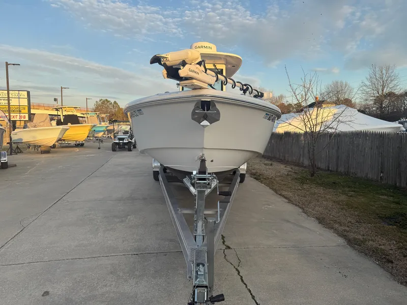 Slide: The Image of 2023 Everglades 273 Center Console boat on trailer, parked outdoors. - 2