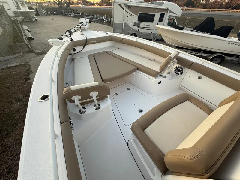 Slide: The Image of 2023 Everglades 273 Center Console boat interior with beige seating and white deck. - 20