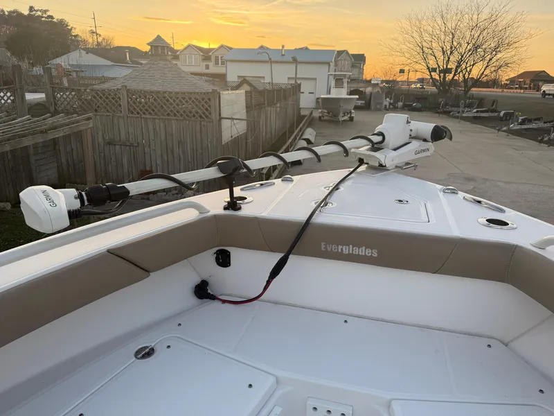 Slide: The Image of 2023 Everglades 273 Center Console boat docked at sunset, featuring a trolling motor. - 24