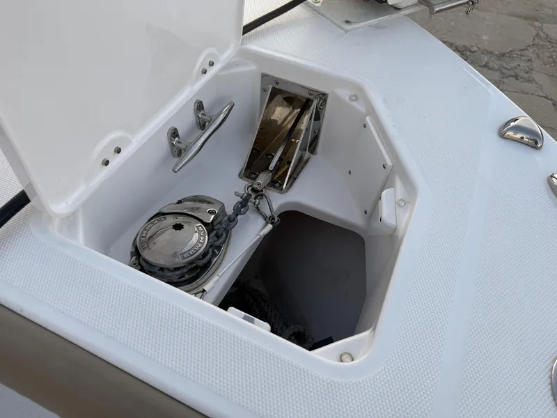 Slide: The Image of 2023 Everglades 273 Center Console anchor locker with chain and winch. - 25