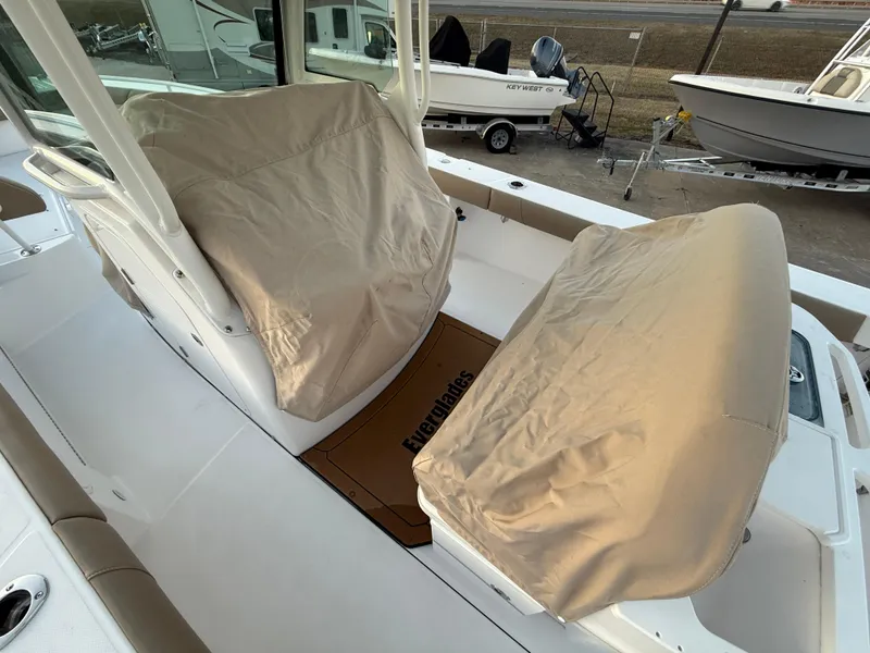 Slide: The Image of 2023 Everglades 273 Center Console boat with covered seating area. - 27