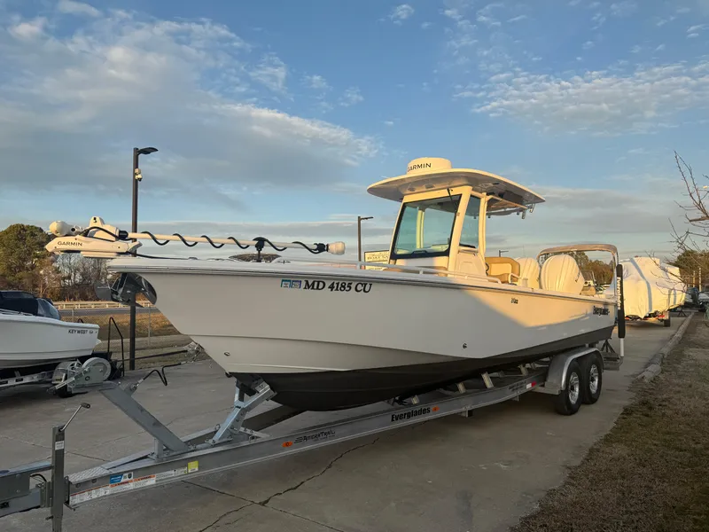 Slide: The Image of 2023 Everglades 273 Center Console boat on trailer under blue sky. - 3