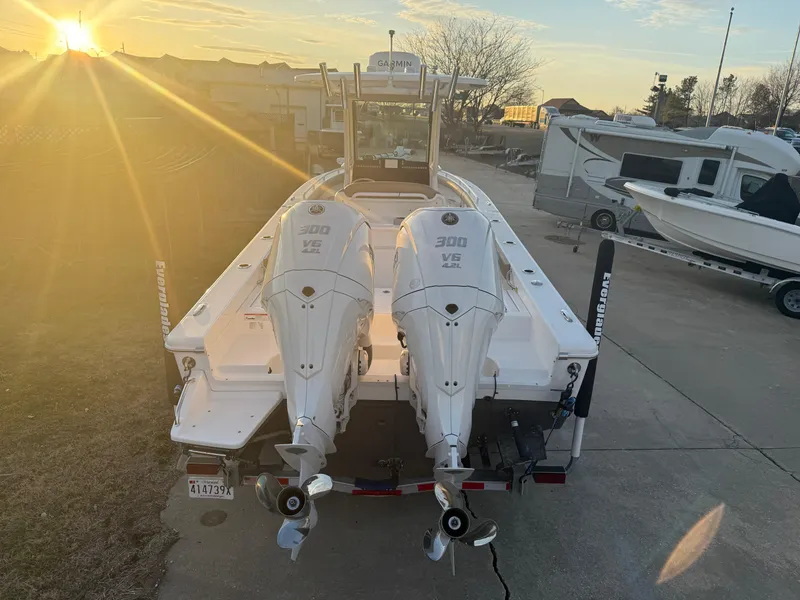 Slide: The Image of 2023 Everglades 273 Center Console boat with twin 300 V6 engines at sunset. - 4