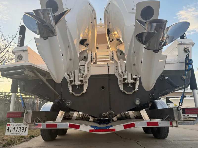 Slide: The Image of 2023 Everglades 273 Center Console boat on trailer, rear view with dual engines. - 5