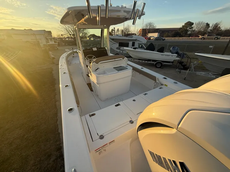 Slide: The Image of 2023 Everglades 273 Center Console boat at sunset, showcasing deck and engine. - 6