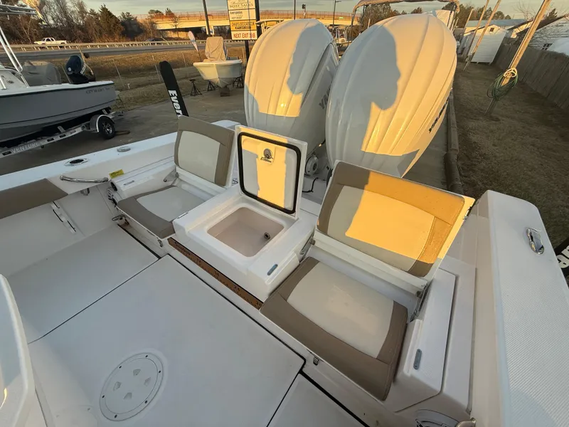 Slide: The Image of 2023 Everglades 273 Center Console boat with dual engines and seating area. - 8