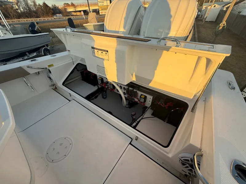 Slide: The Image of 2023 Everglades 273 Center Console boat with open storage compartment, showcasing interior features. - 9