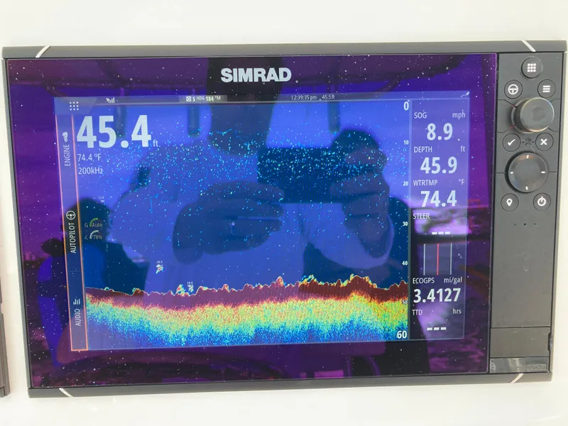Slide: The Image of Simrad fishfinder display on Dusky 252 T, 2021 model, showing depth and water temperature. - 17