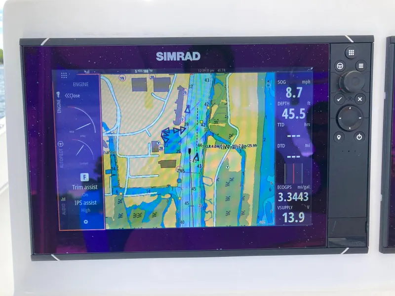 Slide: The Image of Simrad marine GPS display on a 2021 Dusky 252 T boat, showing navigation and depth data. - 18