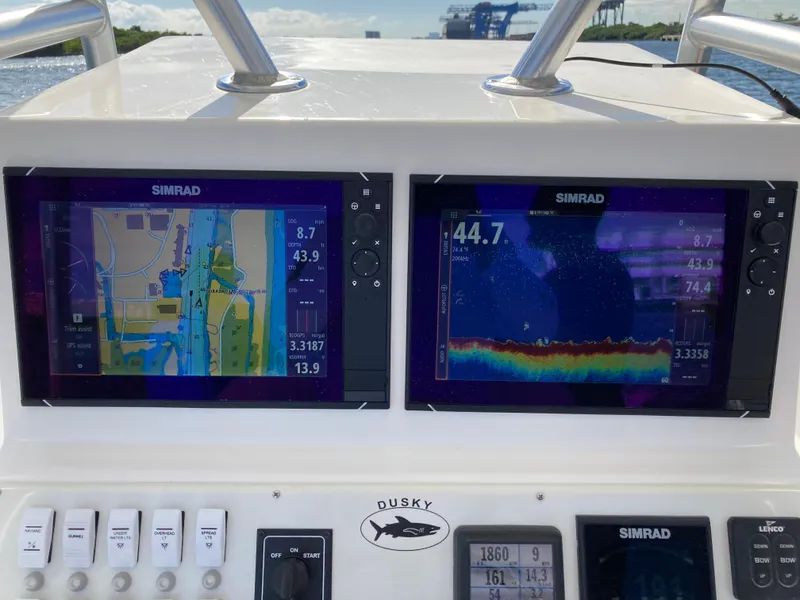 Slide: The Image of Dusky 252 T boat dashboard with dual Simrad navigation displays, 2021 model. - 19