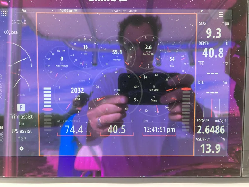 Slide: The Image of Dashboard display of a 2021 Dusky 252 T boat showing engine and navigation data. - 20