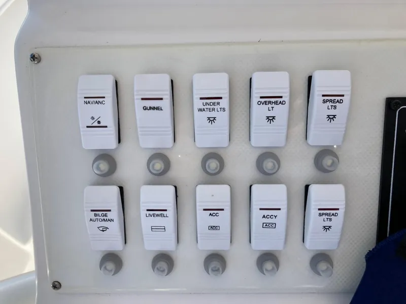 Slide: The Image of Control panel switches on a 2021 Dusky 252 T boat. - 23