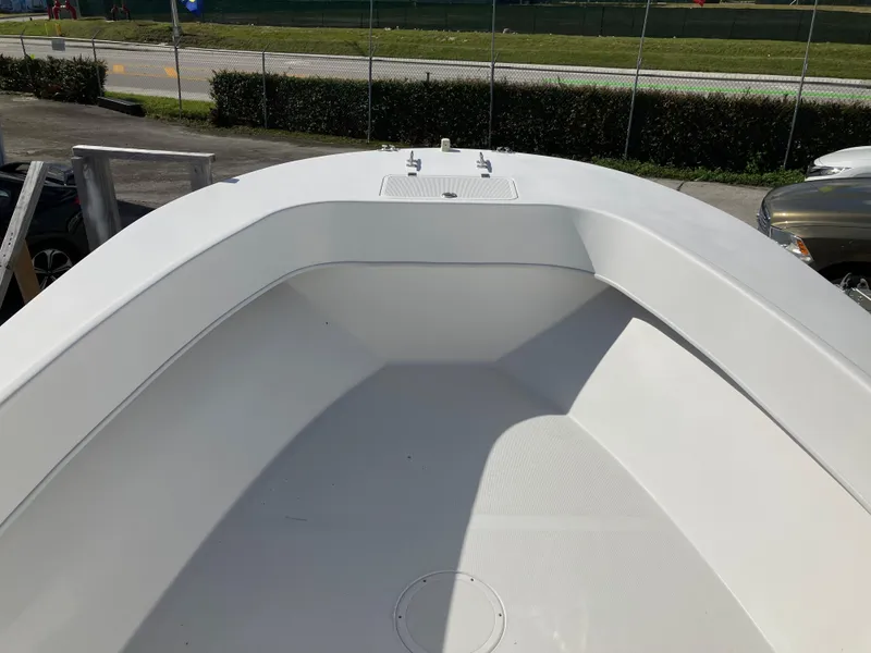 Slide: The Image of 2021 Dusky 252 T boat deck, white interior, outdoor setting. - 24