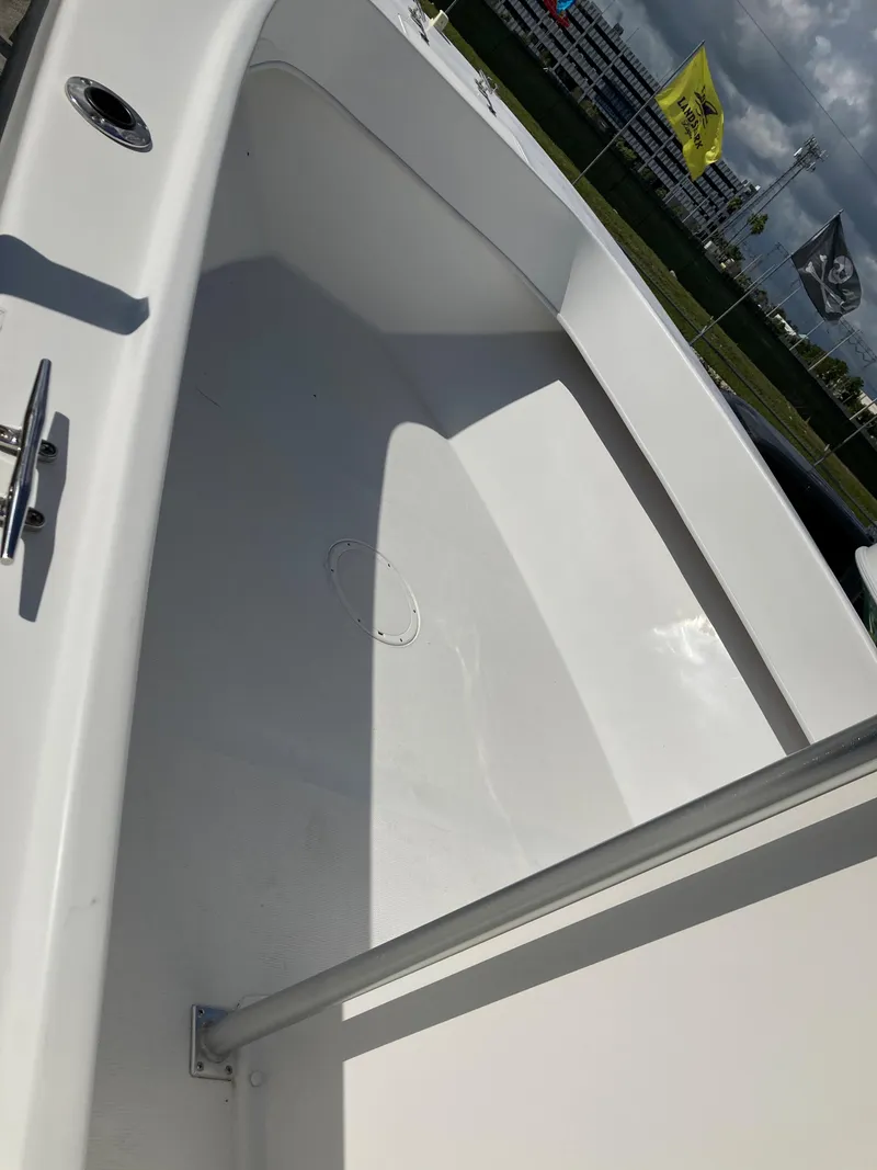 Slide: The Image of 2021 Dusky 252 T boat interior with clean, spacious deck under sunny sky. - 27