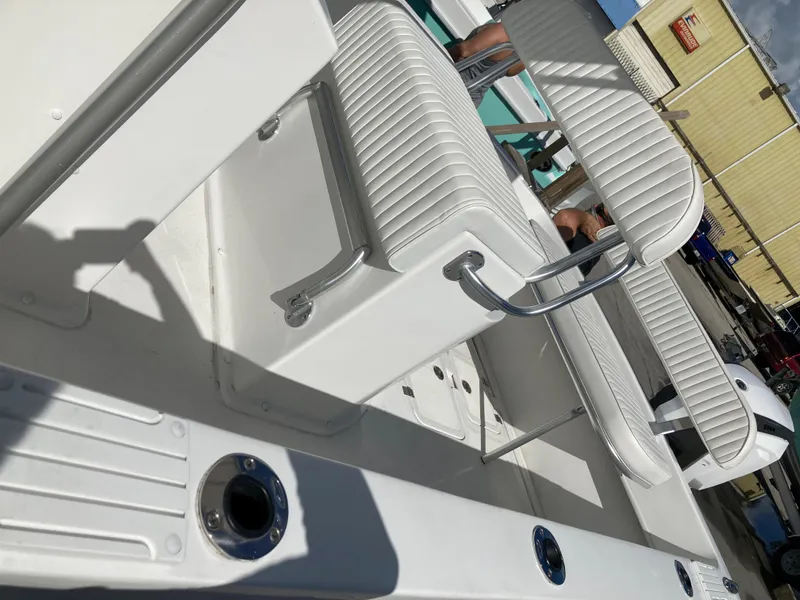 Slide: The Image of 2021 Dusky 252 T boat interior with white seating and deck details. - 28