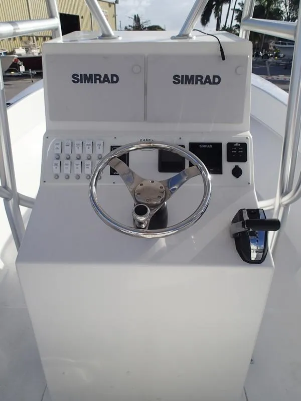 Slide: The Image of Dusky 252 T 2021 boat console with Simrad electronics and steering wheel. - 33