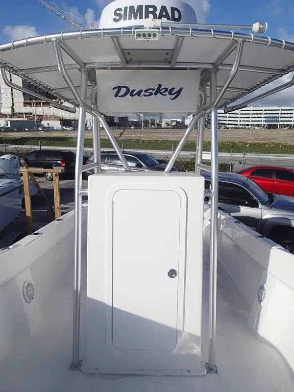 Slide: The Image of 2021 Dusky 252 T boat with Simrad equipment, docked in a marina. - 34