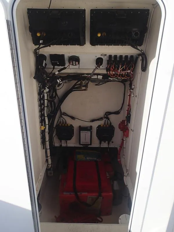 Slide: The Image of Electrical compartment of a 2021 Dusky 252 T boat, showing wiring and components. - 35
