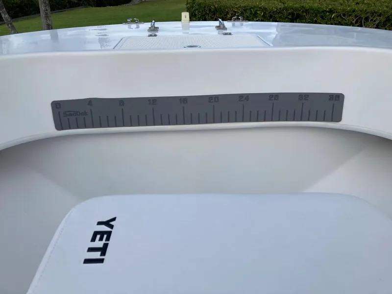 Slide: The Image of Dusky 252 T boat with Yeti cooler and measuring scale, 2021 model. - 37