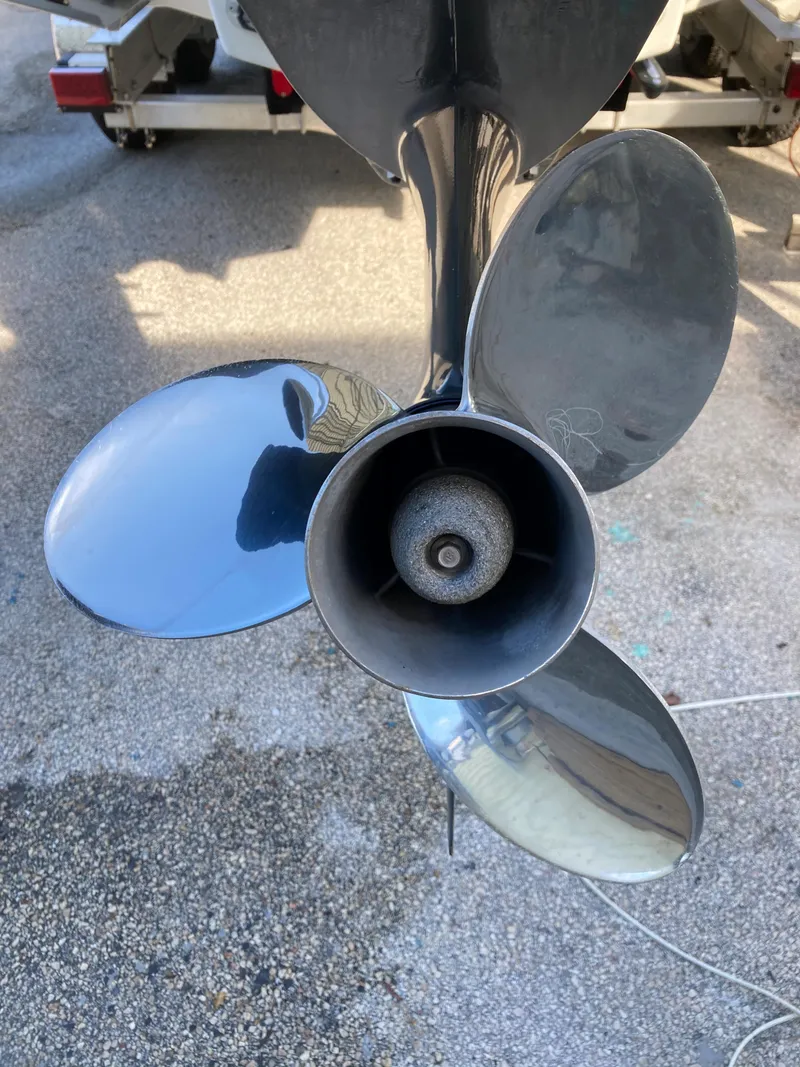 Slide: The Image of Close-up of a Dusky 252 T 2021 boat propeller with four shiny blades. - 39