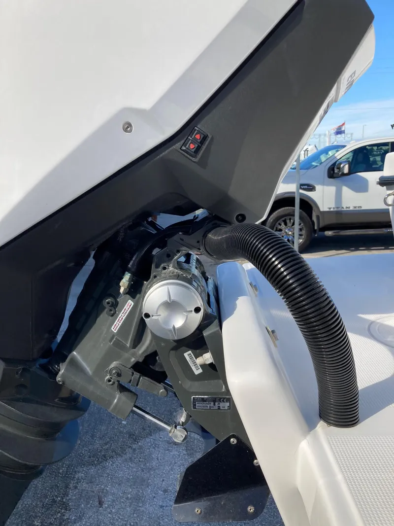 Slide: The Image of Close-up of a 2021 Dusky 252 T boat engine component with visible wiring. - 40