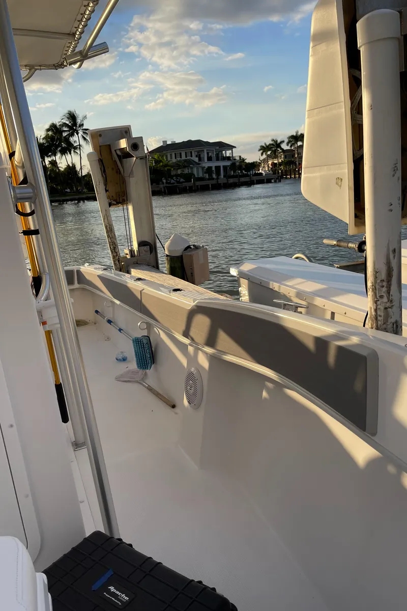 Slide: The Image of 2021 Dusky 252 T boat on water at sunset, with scenic waterfront view. - 42