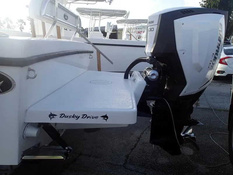 Slide: The Image of 2021 Dusky 252 T boat with Evinrude engine, featuring Dusky Drive platform. - 45