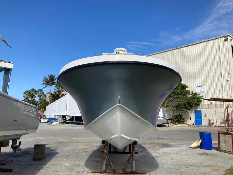 Slide: The Image of Dusky 252 T boat, 2021 model, docked outdoors under clear blue sky. - 5