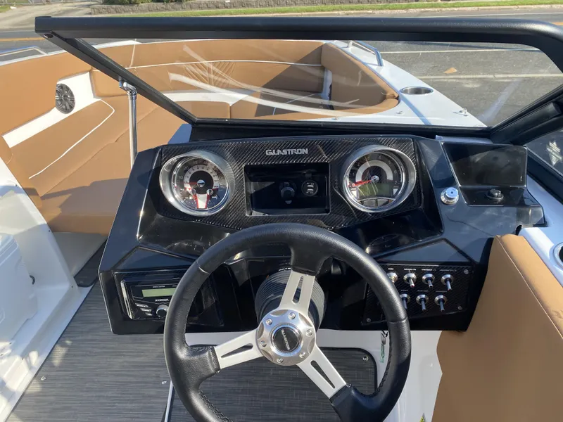 Slide: The Image of 2023 Glastron GTD 220 boat dashboard with steering wheel and instrument panel. - 5
