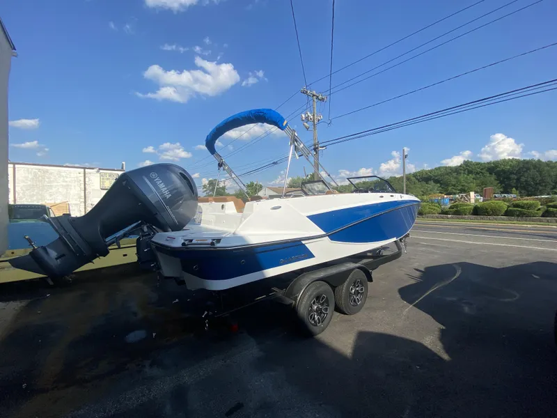 Slide: The Image of 2023 Glastron GTD 220 boat with Yamaha outboard motor on trailer, parked outdoors. - 9